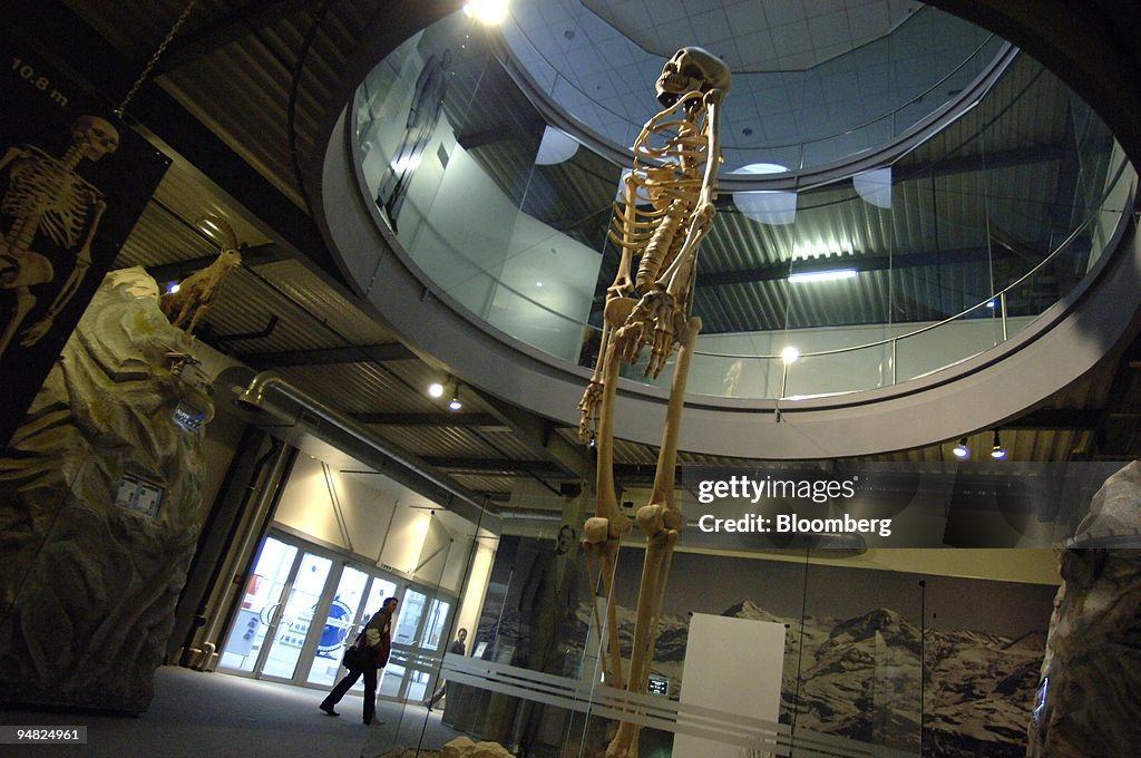Visitors walk by a ten meter high skeleton in the Giants exh