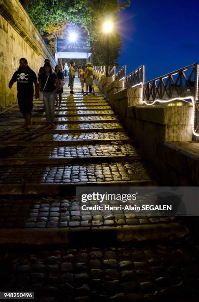 Srolling throught Rome : banks of the Tiber at night near Cestio bridge. Night manifestation Lungo il Tevere.