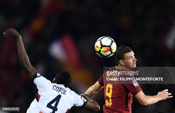 Roma's forward from Bosnia, Edin Dzeko and Genoa's midfielder from Ghana, Isaac Cofie go for a header during the italian Serie A football match Roma...