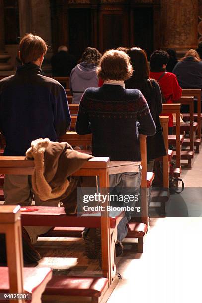 Visitors pray in Saint Peter's cathedral in Rome, Italy, Friday, February 25, 2005. Pope John Paul II was taken to a hospital with breathing problems...