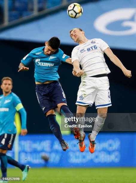 Matias Kranevitter of FC Zenit Saint Petersburg and Yevgeni Lutsenko of FC Dinamo Moscow vie for a header during the Russian Football League match...