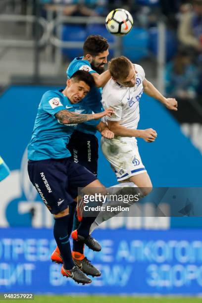 Matias Kranevitter and Miha Mevlja of FC Zenit Saint Petersburg vie for the ball with Yevgeni Lutsenko of FC Dinamo Moscow during the Russian...