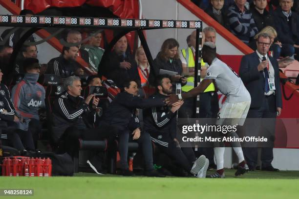 Jose Mourinho manager of Manchester United applauds as Paul Pogba shakes hands with his assistant Rui Faria during the Premier League match between...