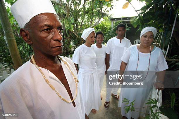 Canomble priest, or pai de santo, Decio Alves da Silva, left, poses for a photograph with his wife Beth da Silva, far right right, son Juan Catanho...