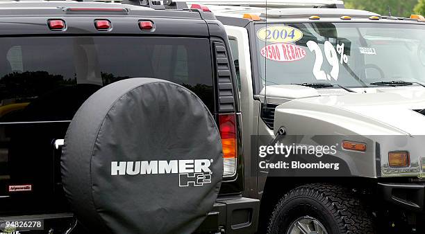 Rebate stickers are affixed to the windshields of 2004 Hummer H2 sport utility vehicles at a Hummer dealership in Naperville, Illinois, on Monday,...