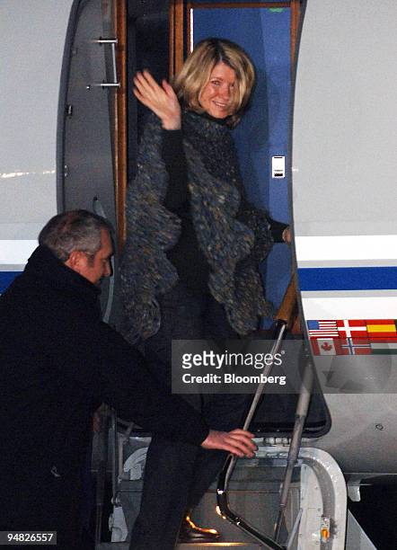 Martha Stewart waves to the media and well-wishers as she boards a private jet at Greenbrier Valley Airport in Lewisburg, W. Va. Early Friday, March...