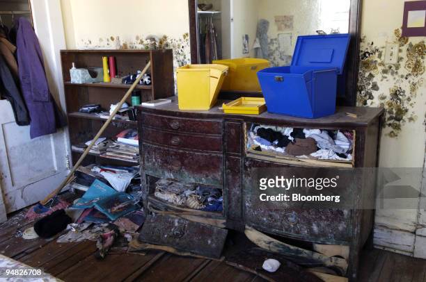 Walls filled with mold and fungus, ruined furniture and buckled floors caused by water damage from Hurricane Katrina are pictured in the home of...