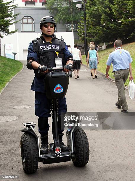 Security guard patrols on a Segway personal transporter in front of the the Group of Eight Summit media center in Rusutsu town, Hokkaido, Japan, on...