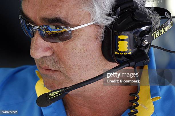 World champion Fernando Alonso's car is reflected in the glasses of Renault team manager Flavio Briatore on the first practice day for the Formula 1...