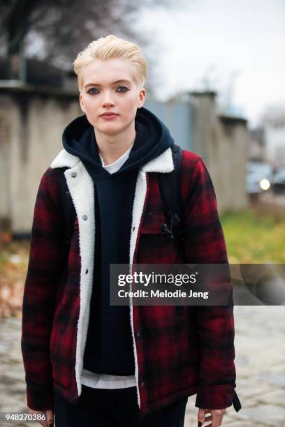 Model Ruth Bell wears a red plaid jacket over a black hoodie after the Roberto Cavalli show during Milan Fashion Week Fall/Winter 2018/19 on February...