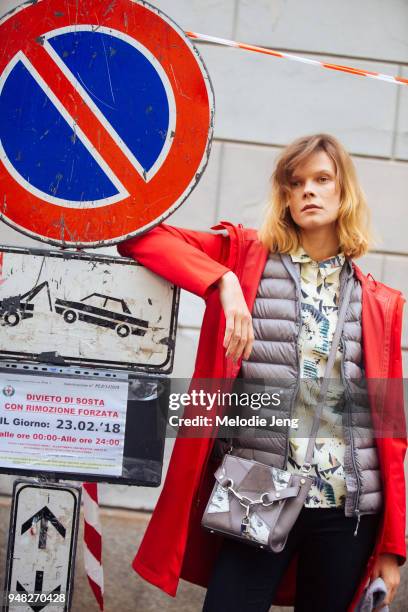 Ukrainian model Irina Kravchenko wears a red jacket and posese with a red street sign during Milan Fashion Week Fall/Winter 2018/19 on February 23,...