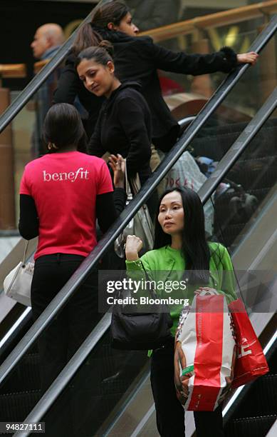 Shoppers fill the escalators of the Brent Cross Shopping Center, Thursday, December 22 in London. U.K. Retailers are attracting more customers and...