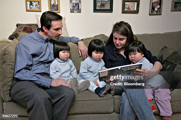 David and Mary Youtz read to their daughters Anna, left, Alice, middle, and Nora right at their home in Tenafly, New Jersey, Thursday, March 9, 2006....