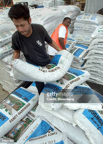 Landscaper Carlos Sagardi loads up the bed of his pickup truck with bags of mulch at the Home Depot Landscape Supply center in Kennesaw, Georgia, on...