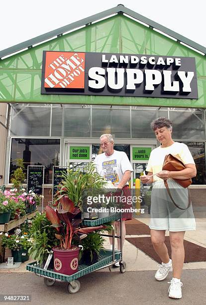 Jim and Linda Staley depart with a cart full of plants after shopping at the Home Depot Landscape Supply center in Kennesaw, Georgia, on Thursday,...