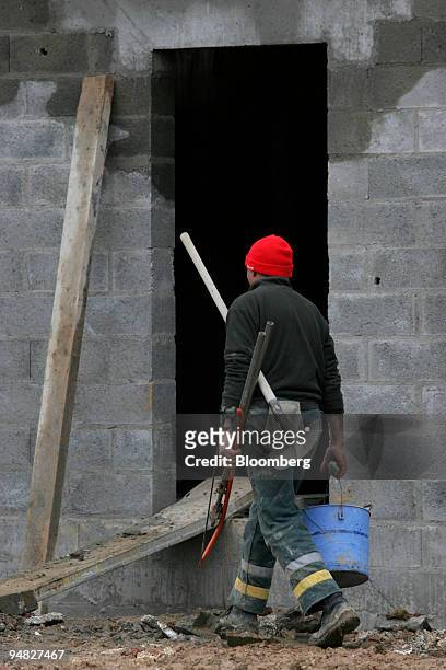 Construction worker is seen at the new building site "Le Champ du Heron" in Saint Aubin near Paris, France, Thursday, March 9, 2006.