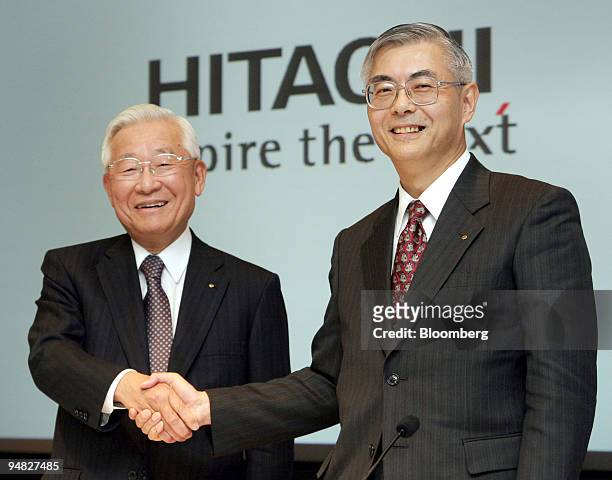 Hitachi Ltd.'s outgoing President Etsuhiko Shoyama, left, shakes hands with incoming President Kazuo Furukawa, right, at a press conference in Tokyo,...