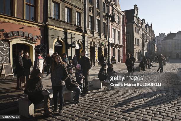 People in the Old Market Square or Stary Rynek in Poznan in Poland, on November 12, 2011. The central square of the city established in 1253 on the...