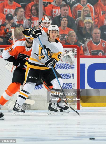 Carl Hagelin of the Pittsburgh Penguins waits to deflect a shot on goal against Brandon Manning and Brian Elliott of the Philadelphia Flyers in Game...