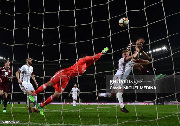 Torino's Italian defender Lorenzo De Silvestri heads the ball to score during the Italian Serie A football match Torino vs AC Milan at the Olimpic...