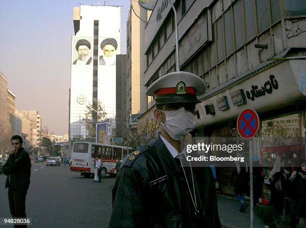 Police officer Mohammad Hossein Sadeghi wears a face mask to protect against smog during traffic duty in Tehran, Iran, Monday, December 19, 2005. The...