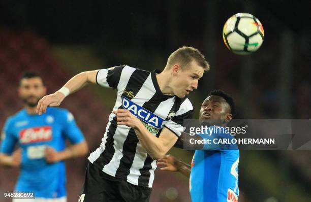 Udinese's Italian defender Gabriele Angella heads the ball as fighting with Napoli's Guinean midfielder Amadou Diawara during the Italian Serie A...