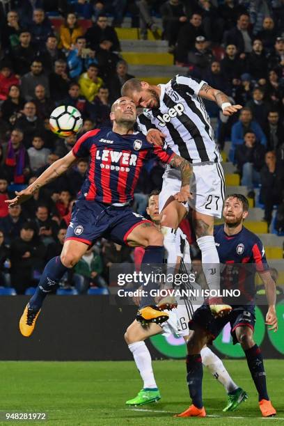 Juventus' midfielder Stefano Sturaro and Coprone's defender Bruno Martella go for a header during the Italian Serie A football match FC Crotone vs...