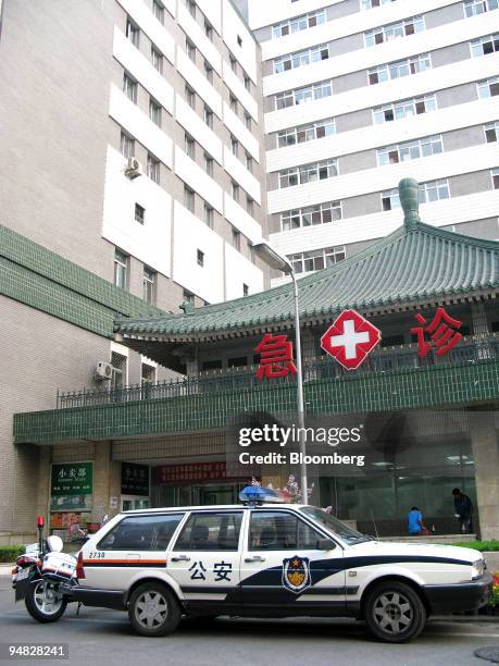 Police car stands parked outside Xie He Hospital in Beijing, China, on Saturday, Aug. 9, 2008. An American tourist was stabbed to death today in...