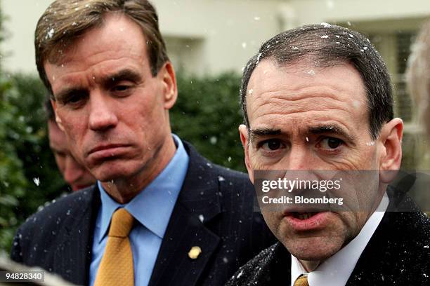 Governors Mark Warner, left, of Virginia. And Mike Huckabee, right, of Arkansas, speak to reporters outside the White House after meeting with...