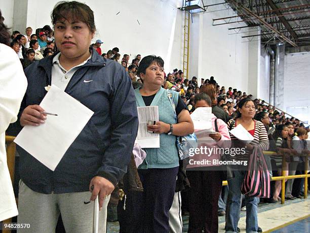 Women line up to receive their monthly stipend from the social policy program Oportunidades in Mexico City on Thursday, Aug. 7, 2008. The program...