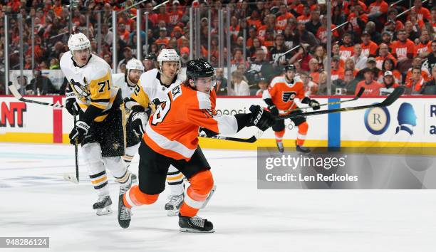 Nolan Patrick of the Philadelphia Flyers takes a slapshot against Carl Hagelin, Evgeni Malkin and Phil Kessel of the Pittsburgh Penguins in Game...