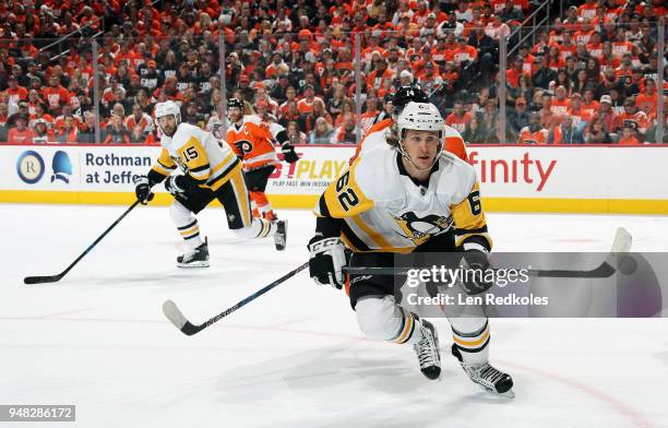 Carl Hagelin and Riley Sheahan of the Pittsburgh Penguins skate against Sean Couturier and Claude Giroux of the Philadelphia Flyers in Game Three of...