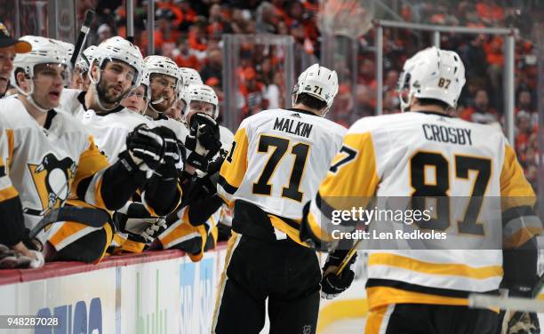 Evgeni Malkin and Sidney Crosby of the Pittsburgh Penguins celebrates a second period goal against the Philadelphia Flyers with teammates on the...