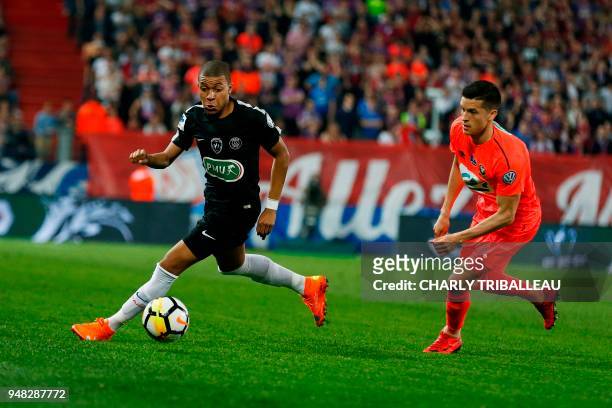 Paris Saint-Germain's French forward Kylian Mbappe outruns Caen's Belgian midfielder Stef Peeters during the French cup semi-final match between Caen...