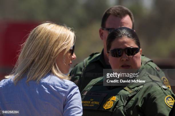 Department of Homeland Security Secretary Kirstjen Nielsen looks in the direction of protesters on the Mexico side of the border demonstrating...
