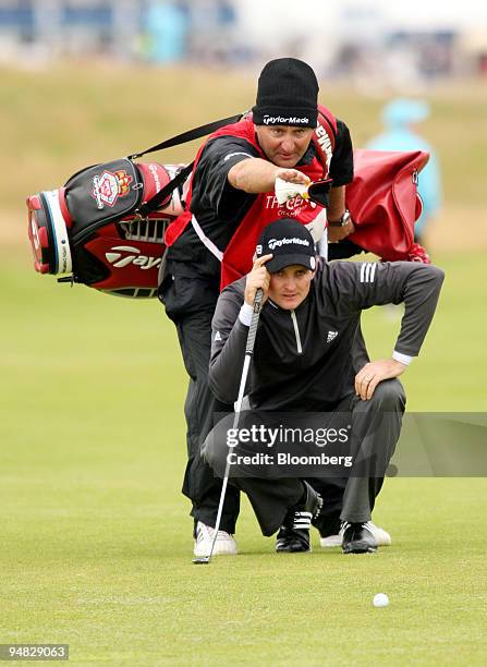 Justin Rose of the U.K., with his caddie line up a putt on the 1st green during day three of the British Open Championship at Royal Birkdale,...