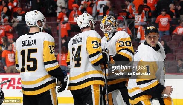 Riley Sheahan, Tom Kuhnhackl, Matthew Murray and Casey DeSmith of the Pittsburgh Penguins celebrate after defeating the Philadelphia Flyers 5-1 in...