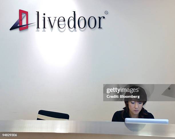 Receptionist works at the entrance to Livedoor's headquarters in Tokyo, Thursday, February 24, 2005. Shares of Fuji Television Network Inc., the...