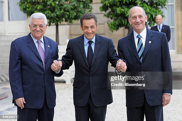 Nicolas Sarkozy, France's president, center, greets Mahmoud Abbas, president of the Palestinian Authority, left, and Ehud Olmert, Israel's prime...