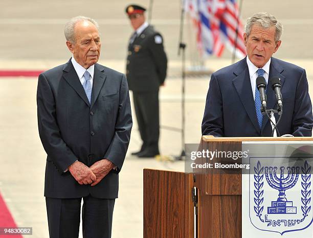 President George W. Bush, right, speaks on his arrival at Ben Gurion Airport, as Shimon Peres, Israel's president, left, listens during the arrival...