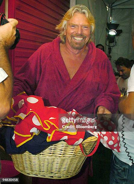 Virgin Group Chairman Sir Richard Branson arrives in a bath robe with washing, for a media conference in Sydney, Australia Monday, March 6, 2006....