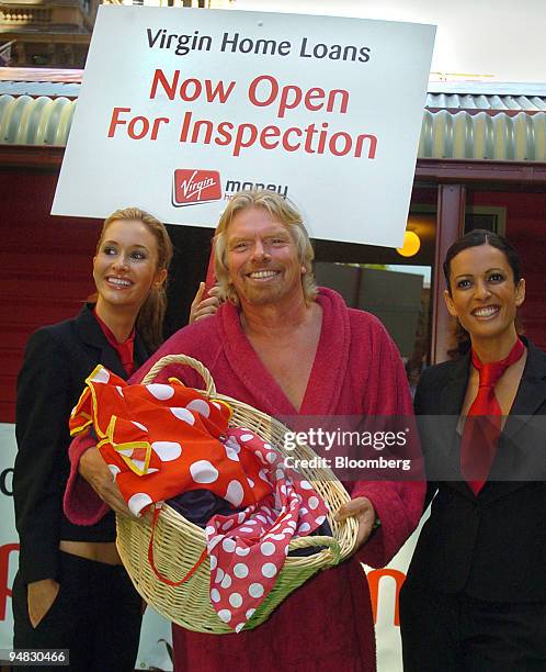 Virgin Group Chairman Sir Richard Branson stands in a bath robe holding a basket of laundry during a media conference in Sydney, Australia Monday,...