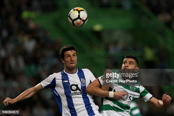 Porto's Spanish defender Ivan Marcano vies with Sporting's midfielder Rodrigo Battaglia from Argentina during the Portugal Cup semifinal second leg...