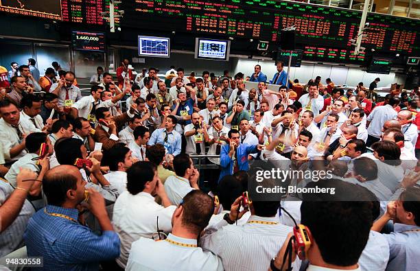 Traders signal orders at the Brazilian Bolsa de Mercadorias e Futuros, or Brazilian Mercantile and Futures Exchange , in Sao Paulo, Brazil, on...