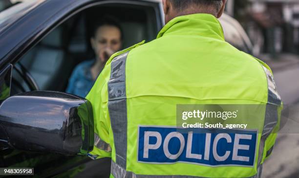 police man pulled over car - traffic police stock pictures, royalty-free photos & images