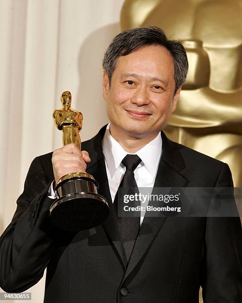 Director Ang Lee holds his Oscar for best director, backstage at the Academy Awards on March 5, 2006. Lee won best director for "Brokeback Mountain."