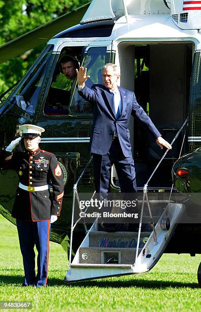 President George W. Bush, waves to onlookers while boarding Marine One to depart for a trip to the Middle East on the South Lawn of the White House...