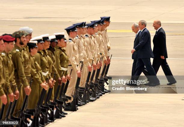 President George W. Bush, center, Shimon Peres, Israel's president, center, and Ehud Olmert, Israel's prime minister walk past the honor guard during...