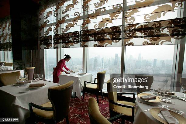 Member of the wait staff sets a table at the restaurant Jade on 36, in Shanghai, China, on Wednesday, May 14, 2008. Chef Paul Pairet serves up the...