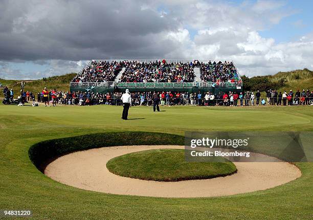 Graham McDowell of Northern Ireland, center, putts on the 7th hole during day four of the British Open Championship at Royal Birkdale, Lancashire,...